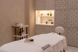 Bamford spa room with treatment bed and wooden walls